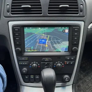 Car's center console with GPS navigation screen showing map view and turn directions