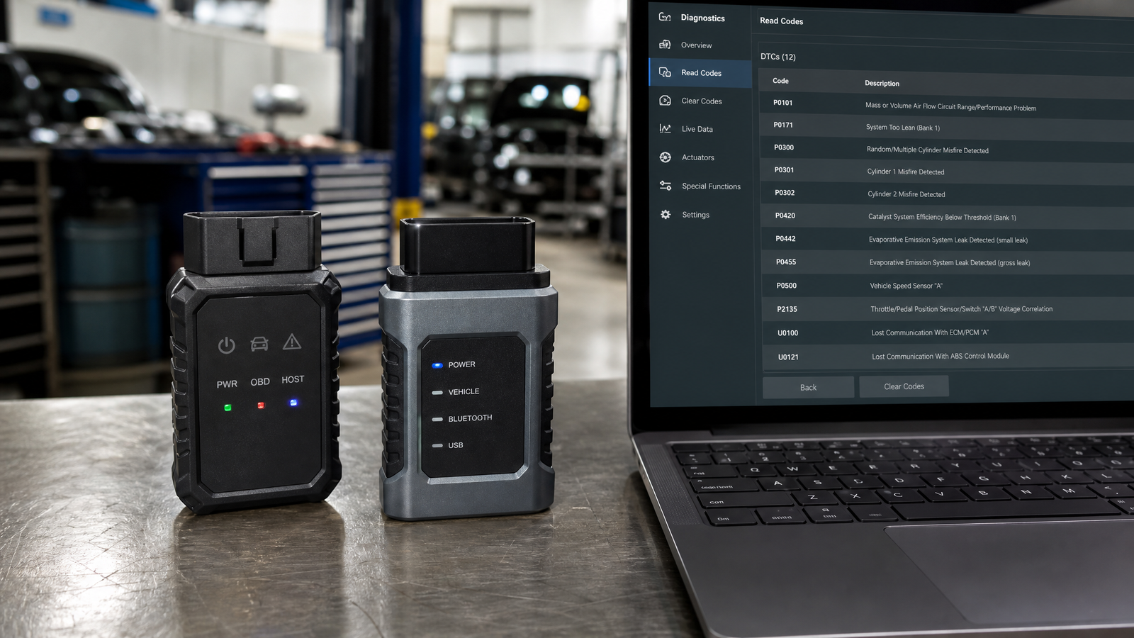 delfi-ds150e-2pcb-multibrand-diagnostic-tool-guide-1 - speedXperts Two diagnostic interfaces on a workshop bench beside a laptop showing diagnostic software