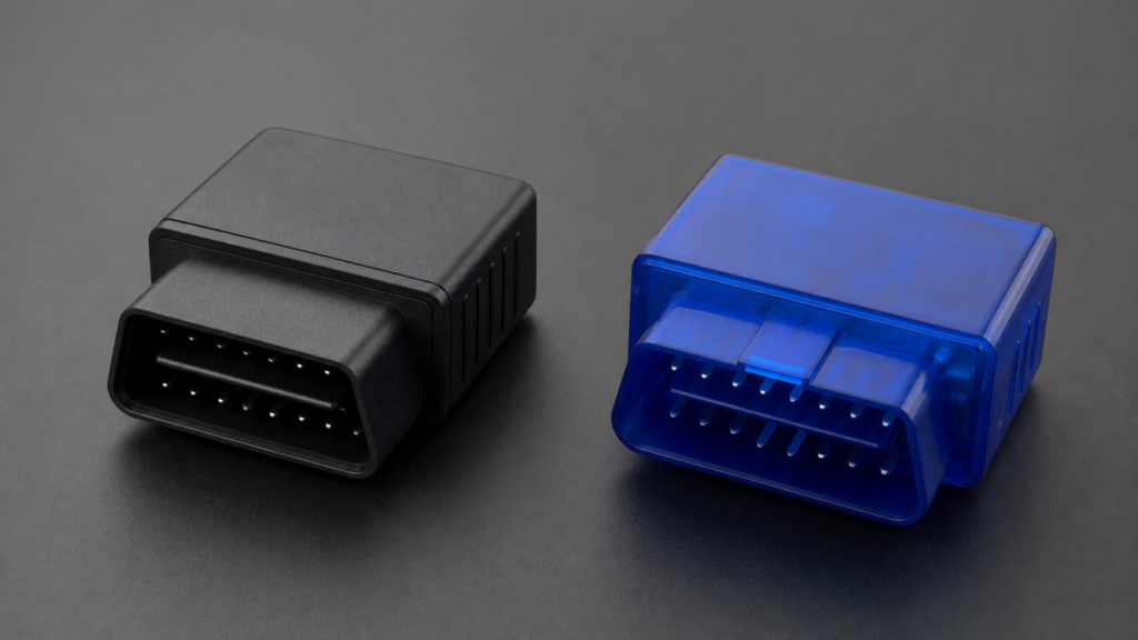 Two Vgate Bluetooth OBD2 adapters placed side by side on a clean surface for comparison